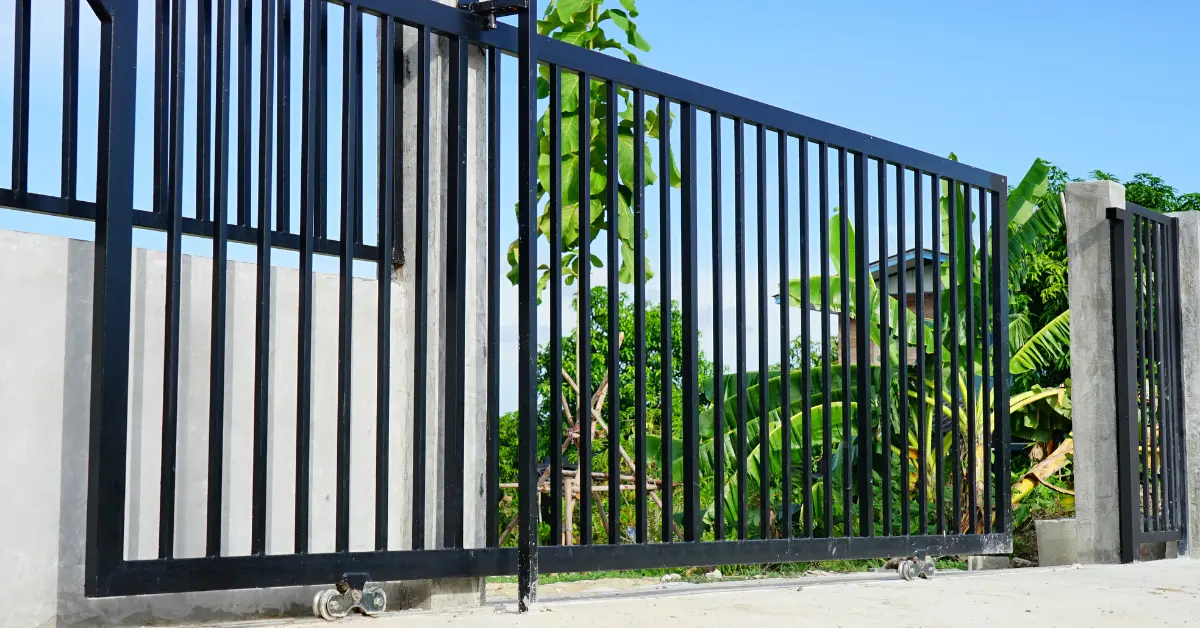 Photo of a black gate with white walls