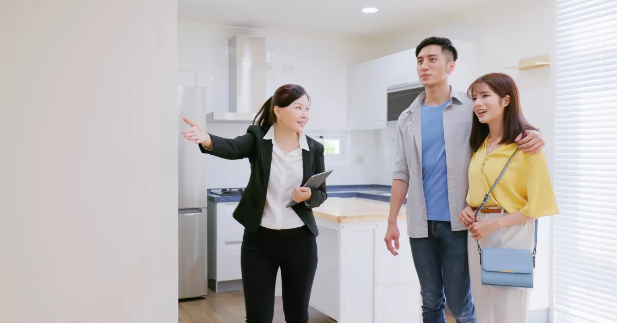 Couple with a real estate agent in the kitchen